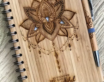 Caderno de bambu ecológico com design de flor de lótus e caneta personalizada.