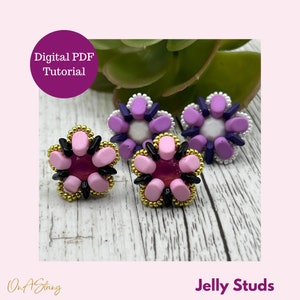 May include: Four flower-shaped stud earrings. The earrings have a central, dark pink gem surrounded by light pink, black, and gold-colored beads. The text "Digital PDF Tutorial" is in a purple circle. The text "Jelly Studs" is at the bottom.