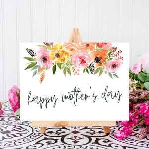 May include: A white card with a watercolor floral design in shades of pink, yellow, and orange. The card says "happy mother's day" in black cursive lettering.