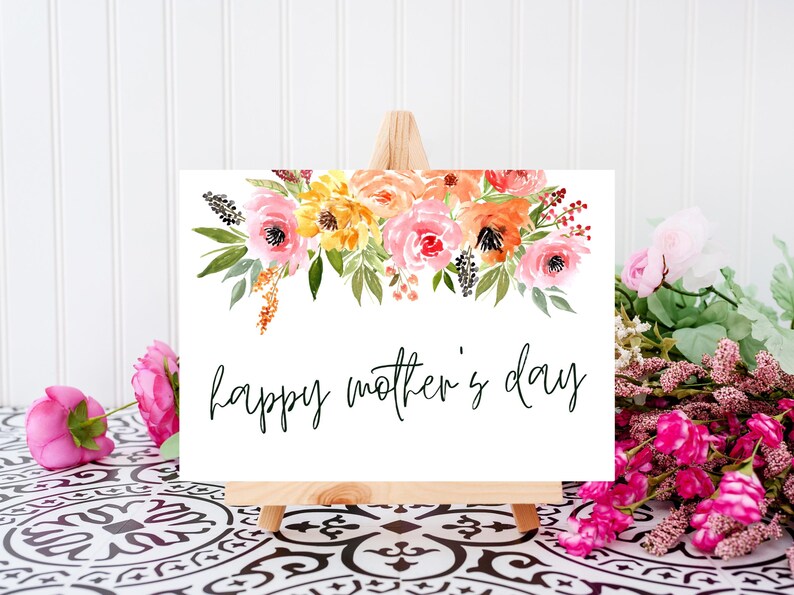 May include: A white card with a watercolor floral design in shades of pink, yellow, and orange. The card says "happy mother's day" in black cursive lettering.