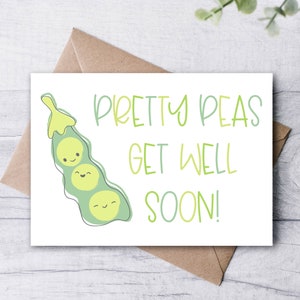 May include: A white greeting card with the text "Pretty Peas Get Well Soon!" in green and light green. The card features a cartoon pea pod with three smiling peas. The card is on a brown envelope.
