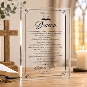 May include: A rectangular clear acrylic plaque featuring black printed text that reads A TRULY GREAT Deacon, followed by a religious message, the name Anthony Smith, ST. PAUL CHURCH, and the years 2008-2026, framed by a decorative black border.