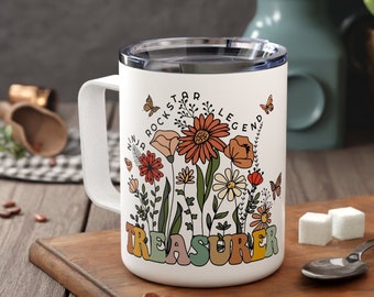 Puede incluir: Taza de viaje de cerámica blanca con un diseño floral y el texto "Rockstar Legend Treasurer".