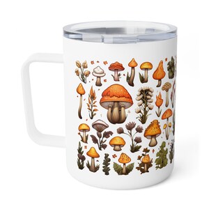 May include: White ceramic travel mug featuring a colourful illustration of different mushrooms and foliage. The mug has a black handle and a white lid.