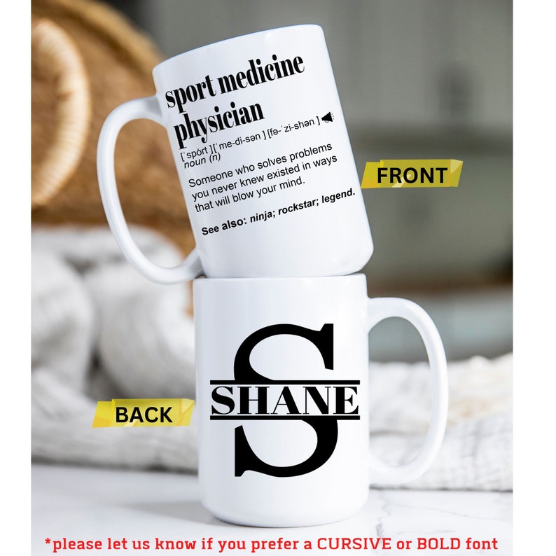 May include: White ceramic mug with a black handle. The front of the mug has a definition for "sport medicine physician" with the text "See also: ninja; rockstar; legend." The back of the mug has a black letter "S" with the name "SHANE" written across the middle.