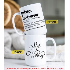 May include: White ceramic mug with a black design that reads "pilates instructor" with a definition and the words "See also: ninja; rockstar; legend". The back of the mug has the text "Mrs. Worley" in cursive.