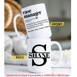 May include: White ceramic mug with a black design. The front of the mug reads "case manager" with a definition and the back of the mug has a black letter "S" with the name "SHANE" written across the middle.