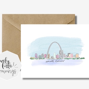 May include: A watercolor illustration of the St. Louis Arch and the city skyline. The arch is drawn in gray, the buildings are in shades of pink, purple, and blue, and the sky is a light blue. The text "saint louis" is written in cursive below the arch.