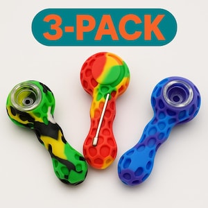 May include: A 3-pack of colorful silicone pipes. One is green with black and yellow camouflage, one is red with yellow and green, and the third is blue with purple. The text "3-PACK" is above the pipes.
