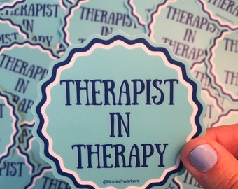 May include: A blue and white sticker with the text "Therapist in Therapy" and the social media handle "@SocialTwerkers".