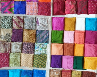 May include: A patchwork quilt made from colorful fabric scraps. The quilt is made up of squares of different colors and patterns, including floral, paisley, and geometric designs. The quilt is a vibrant and eclectic mix of colors and textures.