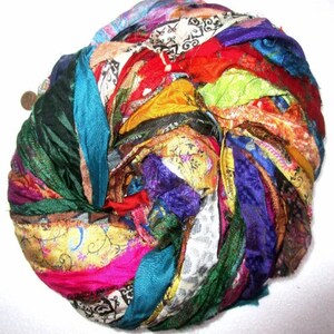May include: A ball of colorful silk ribbon yarn. The yarn is made from recycled saris and is perfect for crafting.