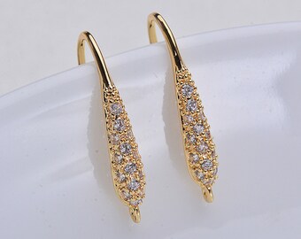 May include: A pair of gold-tone dangle earring findings with clear cubic zirconia stones.