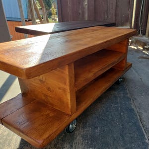 2 Mobile Media Consoles shown in a natural oak stain and a dark oak stain