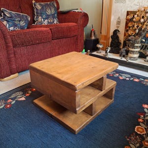 Customer image showing the smallest size of the coffee table in a natural oak wood stain