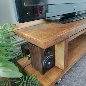 detailed image of the Wooden Tv Cabinet with Castor Wheels. Showing the end compartments utilised with speakers