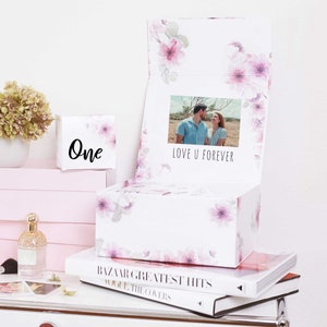 May include: A white box with a floral design and a photo of a couple inside. The box is open and the lid has the text "Love U Forever".
