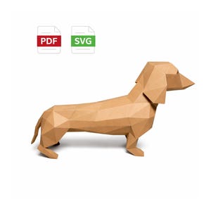 May include: A geometric papercraft dachshund dog in shades of brown. The dog is constructed from folded paper, with visible edges and angles. The image includes PDF and SVG file icons.