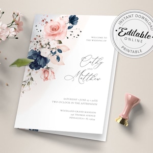 May include: A wedding invitation with a watercolor floral design in shades of blue and pink. The invitation features the names "Cathy and Matthew" and the wedding date "Saturday, June 27, 20XX". The invitation also includes the wedding location, "Woodland Grand Mansion, 236 Thomas Avenue, Pensacola, FL 29654".
