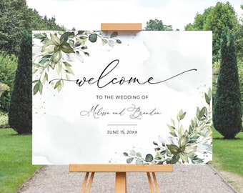 May include: A white wedding welcome sign with green watercolor foliage and gold glitter accents. The text reads "Welcome to the wedding of Melissa and Brandon June 15, 20XX".