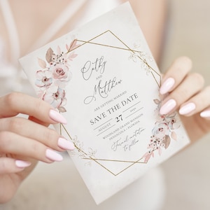 May include: A floral wedding invitation with the names "Cathy" and "Matthew" in elegant script. The invitation features a gold geometric frame and delicate watercolor flowers in shades of pink and beige. The text "Save the Date" is prominently displayed.