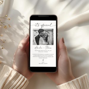 May include: A smartphone displays a wedding announcement. The screen shows a black and white photo of a couple, with the words "it's official" at the top. The announcement includes the couple's names and a message.