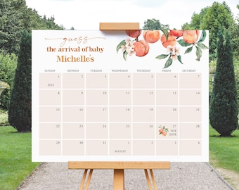 May include: A light peach-colored baby shower calendar with the text "Guess the arrival of baby Michelle's." The calendar features a peach and floral design, with the due date marked on July 27th.