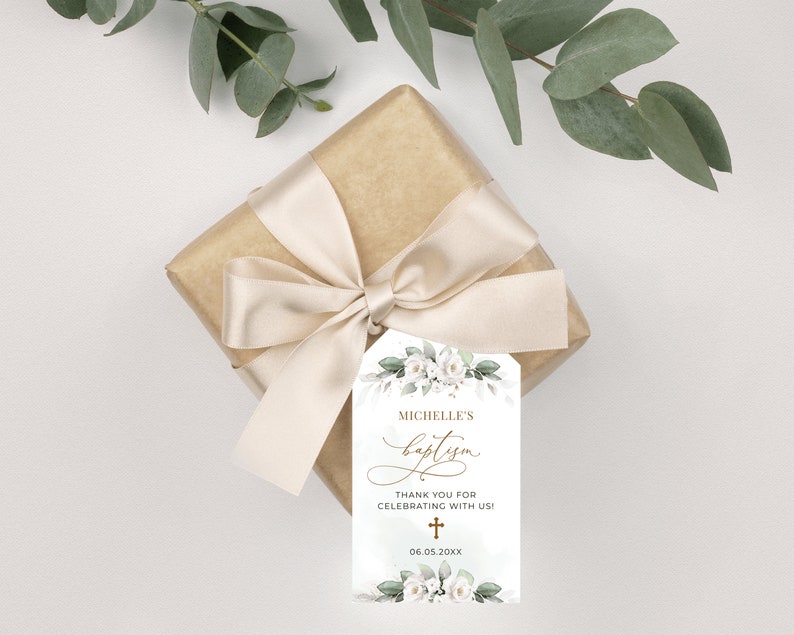 May include: White floral baptism favor tag with gold lettering. The tag says "Michelle's Baptism" and "Thank you for celebrating with us!" with a gold cross and the date "06.05.20XX".