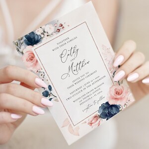 May include: A wedding invitation with a floral design featuring pink and blue flowers. The invitation reads "Together with their families Cathy and Matthew invite you to their wedding ceremony Saturday, June 27, 2020 Two o'clock in the afternoon Woodland Grand Mansion 216 Thomas Avenue Pensacola, FL 34914 Reception to follow"