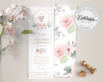 May include: A white bookmark with a gold border and floral design. The bookmark features a chalice with a host, a floral wreath, and the text "Emily's First Holy Communion May 27, 20XX". The bookmark also includes a quote from John 6:35, "I am the bread of life. He who comes to me will not hunger and He who believes in me will never thirst."