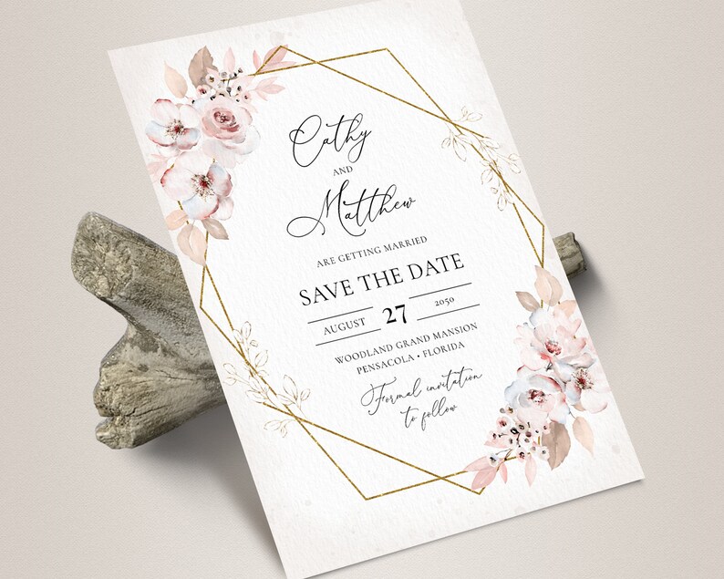 May include: A Save the Date card with floral watercolor accents. The card features the names "Cathy and Matthew" and the date August 27, 2050. A gold geometric frame surrounds the text and floral elements.