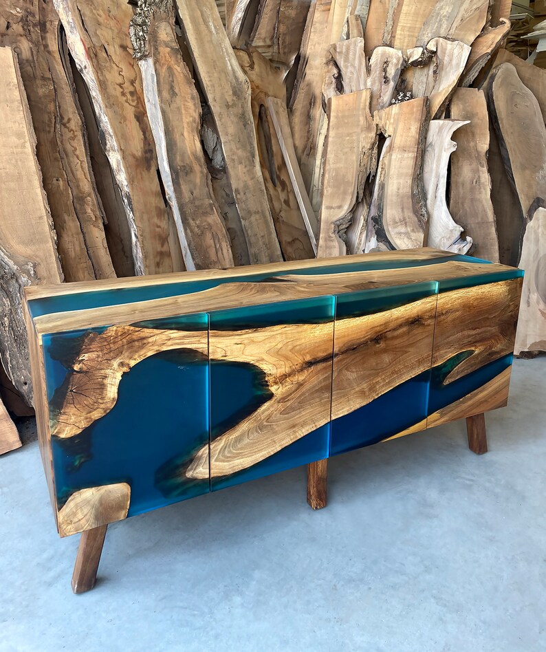 May include: A wooden cabinet with three doors and a blue resin inlay. The cabinet has a modern design and is made of natural wood.