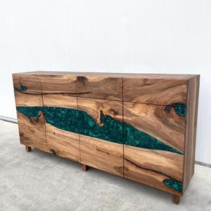 May include: A wooden cabinet with six drawers and a green epoxy resin inlay. The cabinet has a natural wood finish and is made of solid wood.