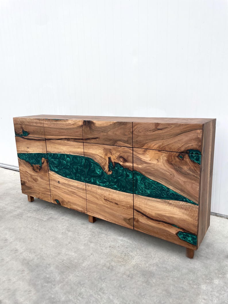 May include: A wooden cabinet with six drawers and a green epoxy resin inlay. The cabinet has a natural wood finish and is made of solid wood.