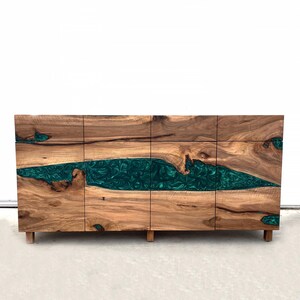 May include: A wooden cabinet with four doors and a green resin inlay. The cabinet has a modern design and is made of natural wood.