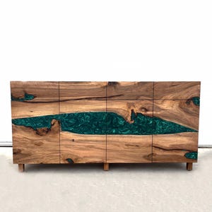 May include: A wooden cabinet with four doors and a green resin inlay. The cabinet has a modern design and is made of natural wood.