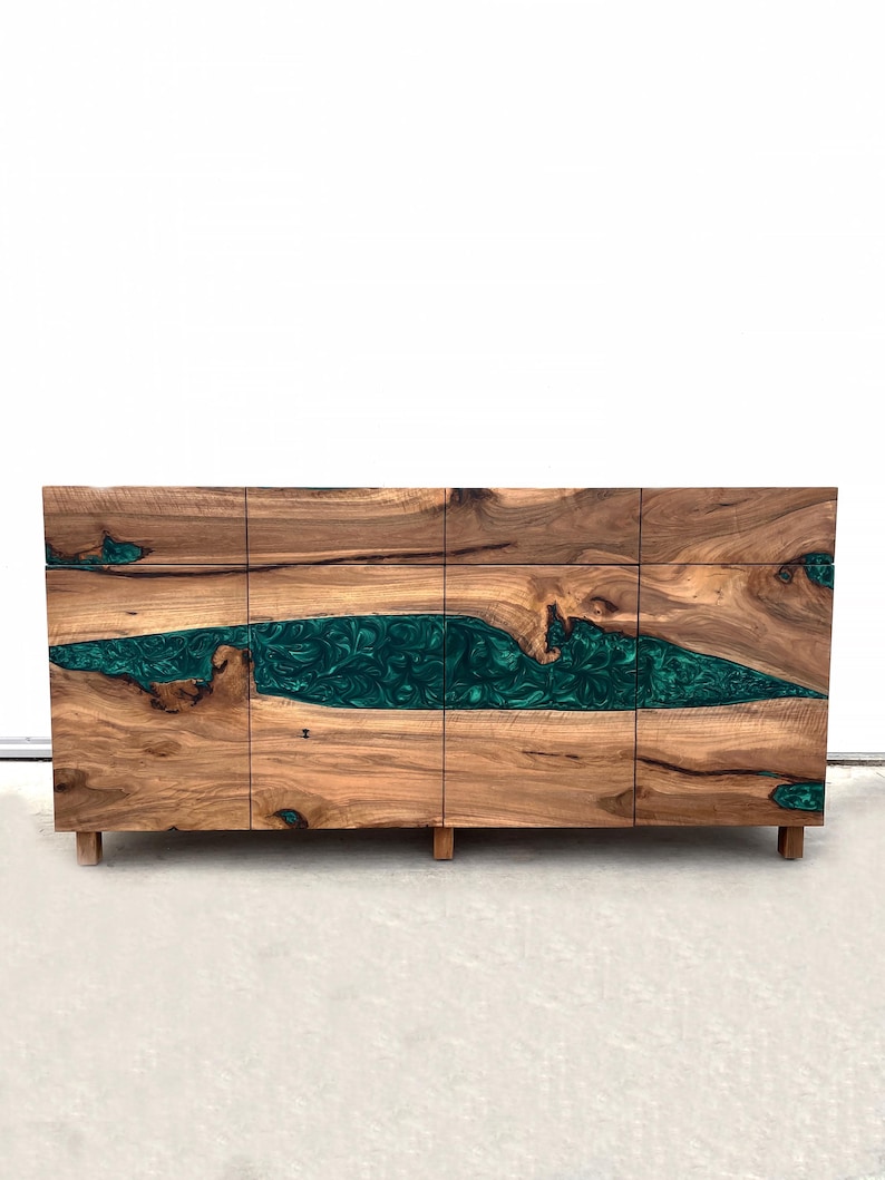 May include: A wooden cabinet with four doors and a green resin inlay. The cabinet has a modern design and is made of natural wood.