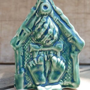 Handcrafted ceramic Tiki mug featuring a grass shack design with vibrant colours and intricate details.