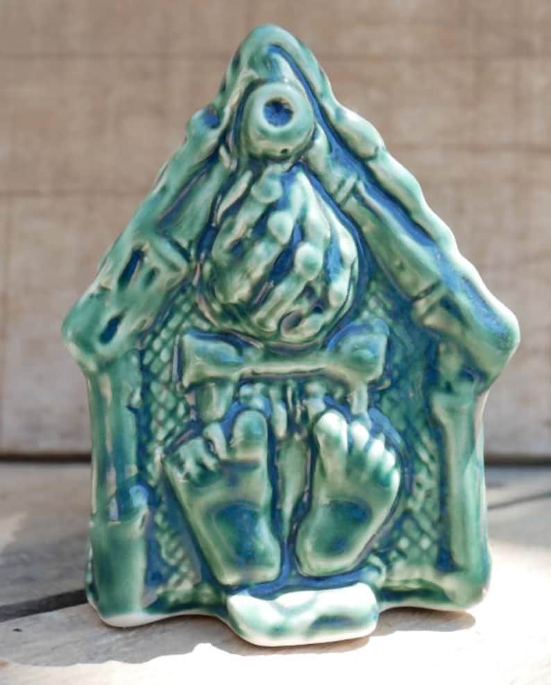 Handcrafted ceramic Tiki mug featuring a grass shack design with vibrant colours and intricate details.