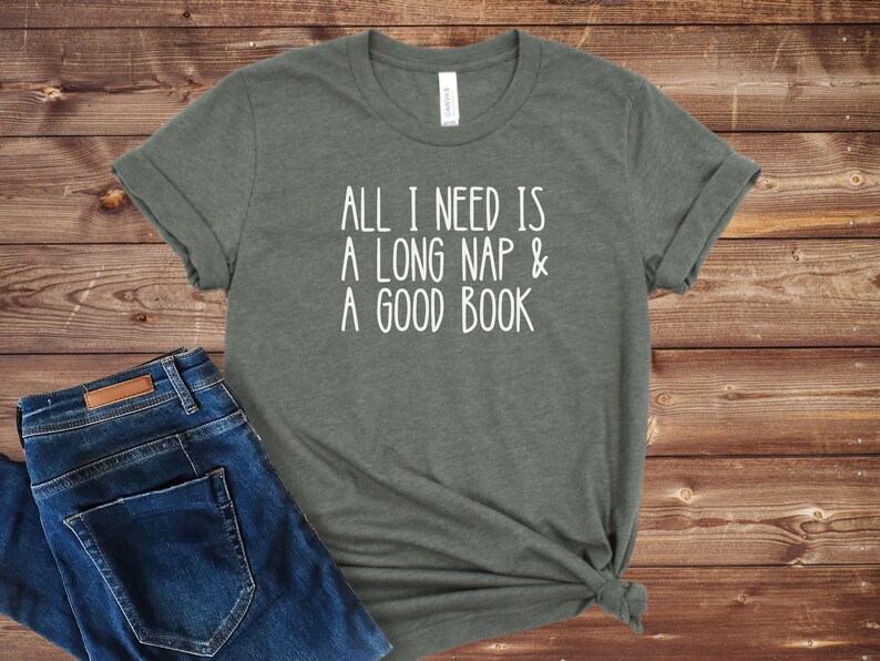 May include: A green t-shirt with the text "All I need is a long nap & a good book" printed in white.