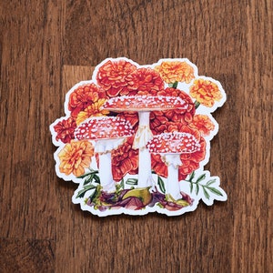 Pegatina de hongo amanita muscaria con caléndulas