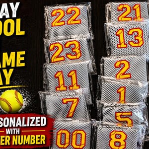 May include: Softball-themed game day accessories. The image shows several personalized cooling towels with player numbers in yellow and red. The text "STAY COOL ON GAME DAY" and "PERSONALIZED WITH PLAYER NUMBER" are also visible.