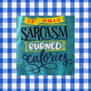 May include: Teal hand towel with embroidered text: "IF ONLY SARCASTM BURNED calories." The text is in black, white, and yellow. The towel is surrounded by a blue and white checkered pattern.