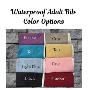 May include: An image displays eight waterproof adult bibs in various colors: purple, gray, teal, tan, light blue, pink, black, and maroon. Each bib is folded and labeled with its color name in white text. The text "Waterproof Adult Bib Color Options" is at the top.