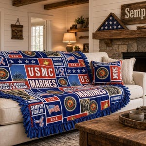 May include: A blue, red, and white fleece throw blanket and matching throw pillow featuring USMC and Marines branding, the text Once a Marine Always a Marine, Semper Fidelis, and USA, with American flag graphics and a blue knotted fringe border.