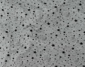 May include: Gray fabric with a black star pattern. The stars are of varying sizes and are scattered randomly across the fabric.