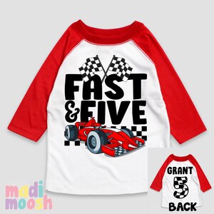 May include: Red and white baseball style t-shirt with a red race car and chequered flags. The text "Fast & Five" is printed on the shirt. The back of the shirt has a black number 5 with a chequered flag design and the word "Grant".
