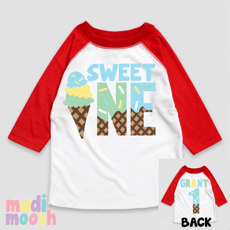 May include: White and red baseball style shirt with the text "SWEET ONE" in blue, green, and brown letters. The letters are decorated with a brown waffle cone pattern and a blue, green, and yellow ice cream cone graphic. The back of the shirt is red and white with the text "GRANT 1" in brown letters.
