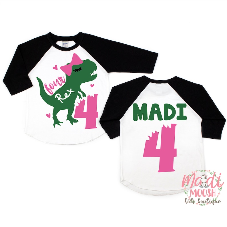 May include: Two white and black baseball shirts with green and pink dinosaur graphics. The front shirt has a green dinosaur with a pink bow and the text "four Rex". The back shirt has the text "MADI" and a pink number "4".