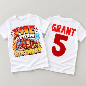 May include: A white t-shirt featuring a red fire truck graphic with the text Five Alarm Birthday and a number 5. The back of the shirt displays the name Grant in red letters above a large red number 5, showcasing a birthday theme design.